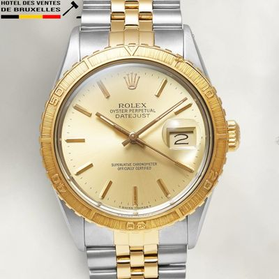 an image of a gold and silver rolex watch on a white background