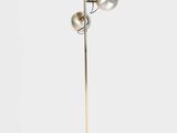 a metal floor lamp with three lamps and a wooden base