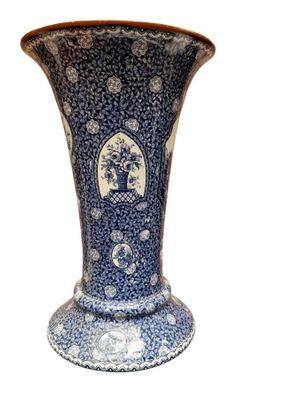 a blue and white vase sitting on a white surface