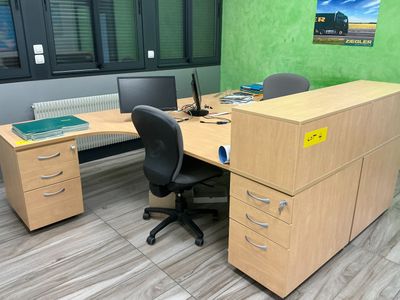 a desk with a chair and a computer on it