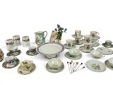 many different types of tea cups and saucers on the table