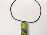 a necklace that has a picture of a kiwi on it