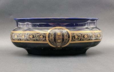 a blue and gold bowl sitting on a table