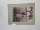an old photo of a woman standing in a field