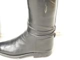 black leather boots with buckles on the side of them