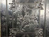 an image of a metal plaque with a scene on it
