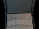 a black case with a set of silver spoons inside of it