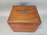 a small wooden box with a metal latch on it