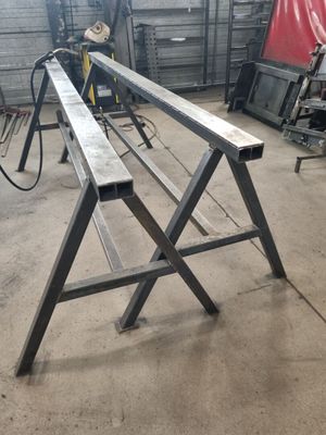 a picture of a table in a garage with a red tarp in the background