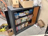 a black bookcase with many books on top of it