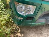 a green truck that is parked on the side of the road