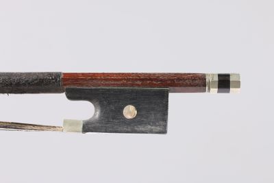 a close up of a bow on a white surface with a wooden handle