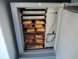 an image of a toaster oven with a bunch of breads in it