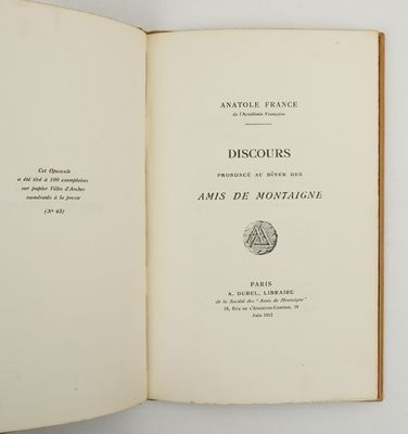 an open book sitting on top of a table next to a white wall