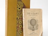 an old book with a yellow cover sitting next to a yellow book