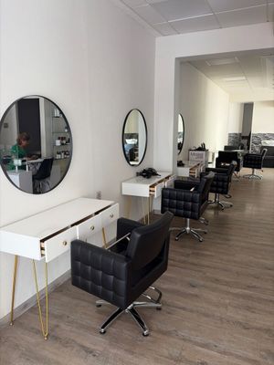 an image of a hair salon with chairs and mirrors