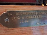 a close up of a wooden box with a metal plate on it