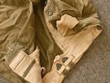 a pair of pants and a jacket laying on the floor