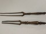 pair of antique brass handled knives on a white surface