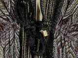 an image of a woman wearing a black and gold jacket