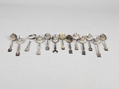 several spoons and spoon spoons are lined up on a white surface