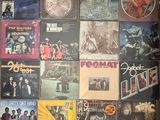 an image of a wall covered with various albums and cds