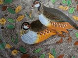 a plate with two birds on it on a table