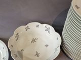 many plates and bowls sitting on a table