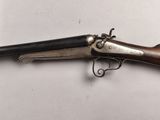 a close up of a gun on a table with a white background