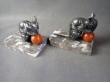 two figurines of elephants sitting on top of each other