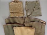 many different bags hanging on the wall next to each other