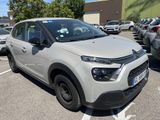 La Citroën blanche est garée sur un parking, à côté d'autres voitures