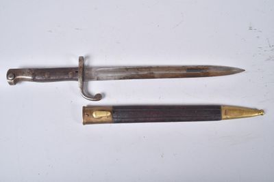 two different types of knives on a white surface