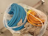a pile of different colored hoses wrapped in plastic