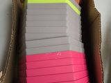 une boîte en carton remplie d'une multitude de notes postales roses et jaunes