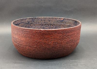 a red bowl sitting on top of a table