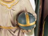 a statue of a man holding a ball in his hand