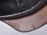 a close up of a pair of black shoes on a white surface