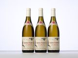 three bottles of wine sitting on top of a white table