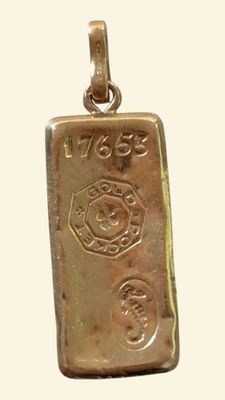 an image of a gold bar pendant with a fire department emblem on it
