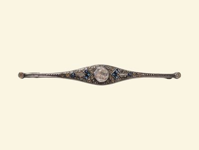 an image of a silver and blue stone broochle on a white background