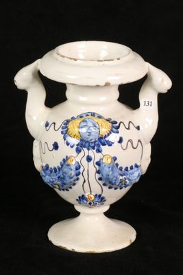 a white vase with a blue and yellow design on it