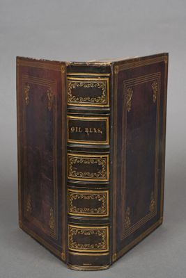 an old book that is open on a table