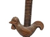 a wooden bird on top of a metal pole