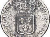 a silver coin with a crown on top of it