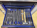 many tools in a blue toolbox on the floor