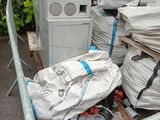 a pile of garbage sitting on a pallet next to a pile of appliances