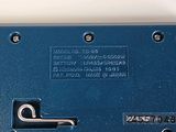 a close up of a blue electrical device on a white surface