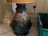 une lampe posée par terre à côté d'une poubelle