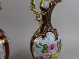 two vases that have been painted with flowers on them